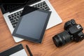 DSLR digital camera with tablet and notebook laptop Royalty Free Stock Photo