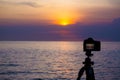 Dslr digital professional camera stand on tripod photographing sea, twilight sky and cloud landscape. nature background.image,pict Royalty Free Stock Photo