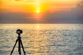 Dslr digital professional camera stand on tripod photographing sea, twilight sky and cloud landscape. nature background.image,pict Royalty Free Stock Photo