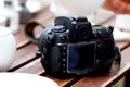 DSLR photo camera standing on table Royalty Free Stock Photo