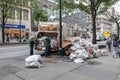 DSNY workers collect trash on a city street. New York Department of Sanitation is responsible for garbage. Truck on the street Royalty Free Stock Photo