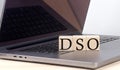 DSO word on wooden block on laptop, business concept Royalty Free Stock Photo