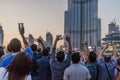 DUABI, UAE - MARCH 10, 2017: Crowds of people observe The Dubai Fountain and Burj Khalifa skyscrape