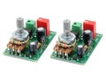 Dual-channel potentiometer modules with adjustable knobs and capacitors on green circuit boards Royalty Free Stock Photo
