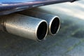 Dual exhaust of a car, concept for emissions and particulate mat Royalty Free Stock Photo