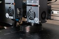 Dual extruder 3d printer printing a black model, idex technology