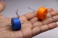 Dual shaft dc motor with plastic frame. Small electric motor with double shaft held in hand