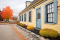 dualtone shutters on historic saltbox, pebble path Royalty Free Stock Photo