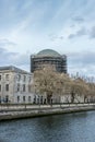 Vertical shot of Four Courts in front of a river in Dublin, Ireland Royalty Free Stock Photo