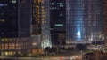 Dubai business bay district with office skyscrapers and traffic on the road intersection aerial night timelapse. Royalty Free Stock Photo