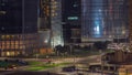 Dubai business bay district with office skyscrapers and traffic on the road intersection aerial night timelapse. Royalty Free Stock Photo