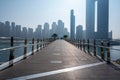 Dubai city silhouette and sea behind the timbered walking terrace bicycle lanes in Dubai