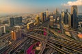 Dubai cityscape with skyscrapers and highways at sunset, modern urban architecture and traffic, United Arab Emirates