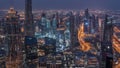 Dubai Downtown skyline futuristic cityscape with many skyscrapers and Burj Khalifa aerial night to day timelapse.