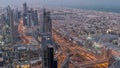 Dubai Downtown skyline futuristic cityscape with many skyscrapers and Burj Khalifa aerial night to day timelapse.