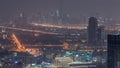 Dubai Downtown skyline row of skyscrapers with tallset tower aerial night to day timelapse. UAE