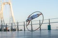 Dubai, February 2020. Cyr Wheel artist with Ferris wheel on background of Dubai during sunset