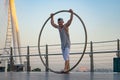 Dubai, February 2020. Cyr Wheel artist with Ferris wheel on background of Dubai during sunset