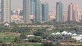 Dubai Golf Course with a cityscape of Gereens and tecom districts at the background aerial timelapse