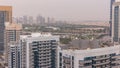 Dubai Golf Course with a cityscape of Gereens and tecom districts at the background aerial timelapse