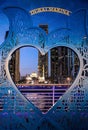 Dubai high-rise buildings and the Marina Mosque at night through a heart frame Royalty Free Stock Photo