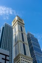 Dubai International Financial Centre DIFC  Iconic The Tower clock amid modern Dubai skyscrapers on blue sky Royalty Free Stock Photo