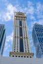 Dubai International Financial Centre DIFC  Iconic The Tower clock amid modern Dubai skyscrapers on blue sky Royalty Free Stock Photo