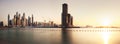 Dubai, January 13, 2023: Modern buildings with gold reflection of sunset on Dubai Marina bay view from Palm Jumeirah, UAE