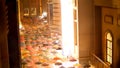 Dubai Mall, in reflection of storefront, dozens of open multi-colored umbrellas, suspended in form of improvised ceiling