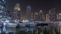 Dubai marina bay with yachts an boats night timelapse Royalty Free Stock Photo