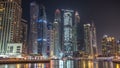 Dubai marina bay with yachts an boats night timelapse Royalty Free Stock Photo