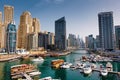 Dubai marina with boats and buildings with gates Royalty Free Stock Photo