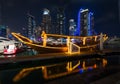 Dubai marina city lights lit up at night with famous landmarK and tourist boat Royalty Free Stock Photo