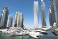 Dubai Marina with luxury skyscrapers and yachts on water pier, UAE