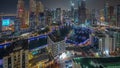 Dubai Marina with several boat and yachts parked in harbor and skyscrapers around canal aerial night timelapse. Royalty Free Stock Photo