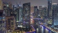 Dubai Marina with several boat and yachts parked in harbor and skyscrapers around canal aerial night timelapse. Royalty Free Stock Photo