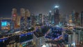 Dubai Marina with several boat and yachts parked in harbor and skyscrapers around canal aerial night timelapse. Royalty Free Stock Photo