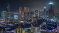 Dubai Marina with several boat and yachts parked in harbor and skyscrapers around canal aerial night timelapse. Royalty Free Stock Photo