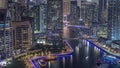 Dubai Marina with several boat and yachts parked in harbor and skyscrapers around canal aerial day to night timelapse. Royalty Free Stock Photo