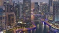 Dubai Marina with several boat and yachts parked in harbor and skyscrapers around canal aerial day to night timelapse. Royalty Free Stock Photo