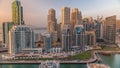 Dubai Marina with several boat and yachts parked in harbor and skyscrapers around canal aerial timelapse. Royalty Free Stock Photo