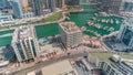 Dubai Marina with several boat and yachts parked in harbor and skyscrapers around canal aerial timelapse. Royalty Free Stock Photo