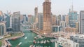 Dubai Marina with several boat and yachts parked in harbor and skyscrapers around canal aerial timelapse. Royalty Free Stock Photo