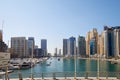 Dubai Marina skyscrapers and boats in harbor in a sunny day, blue sky in Dubai, United Arab Emirates Royalty Free Stock Photo