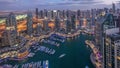 Dubai Marina skyscrapers and jumeirah lake towers view from the top aerial day to night timelapse in the United Arab