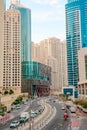 Dubai Marina street with skyscrapers, road, car and Emaar building