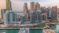 Dubai Marina with several boat and yachts parked in harbor and skyscrapers around canal aerial timelapse. Royalty Free Stock Photo