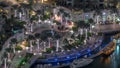 Dubai Marina Walk with fountain and palms aerial Top View night timelapse
