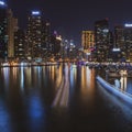 Dubai Marina Yacht Club long exposure square crop at night with lights of skyline and creek for luxury vacation and travel