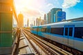 Dubai metro train on rails at background of skyscrapers. Famous outdoor subway Red Line. Royalty Free Stock Photo